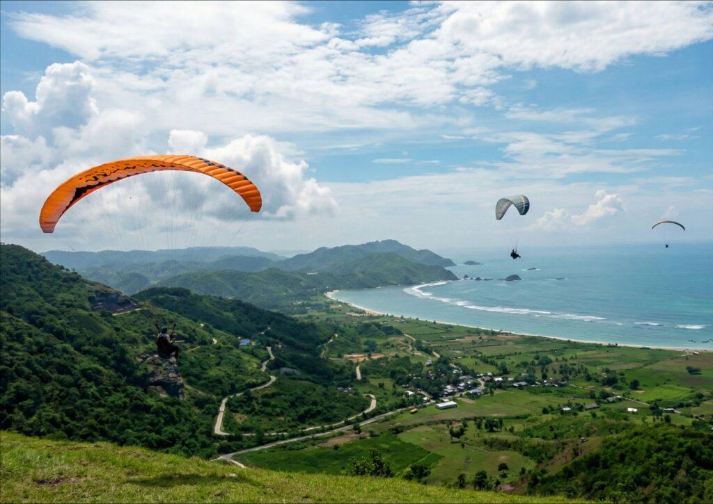 Paragliders above the bay on Lombok's south coast