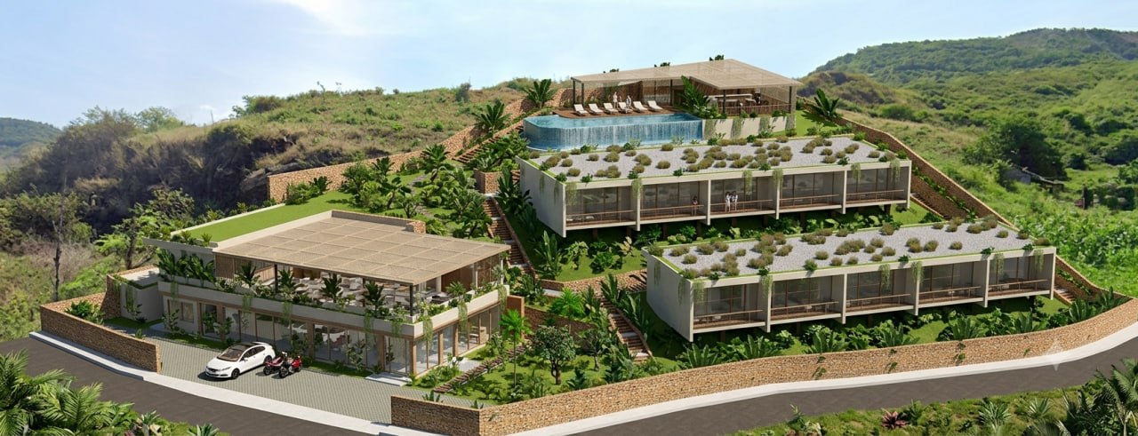 Aerial view of the Nomio resort: two rows of ocean-view studios, infinity pool and arrival building on the hillside